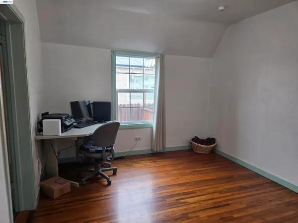 a view of a workspace with furniture and a window