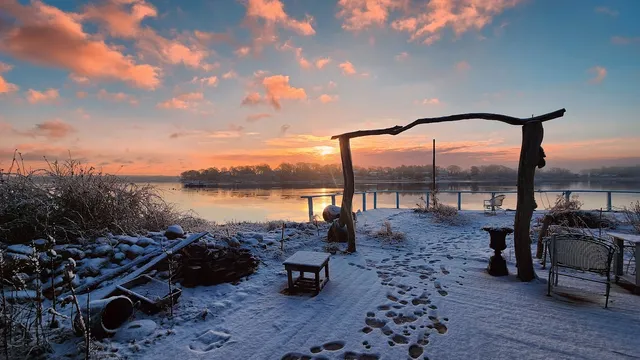 a dining room with furniture a rug and a large window