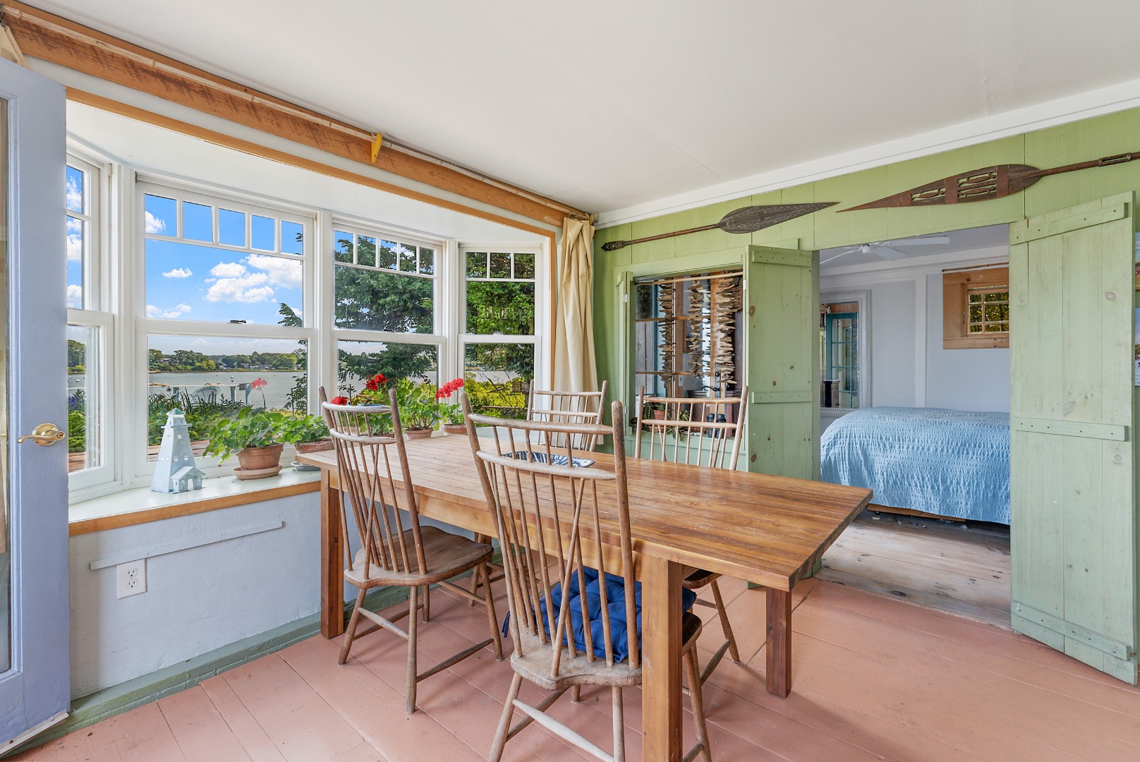 129 Beach Road Vineyard Haven, MA 02568 - Photo 19 of 71 a dining room with furniture a potted plant and a floor to ceiling window