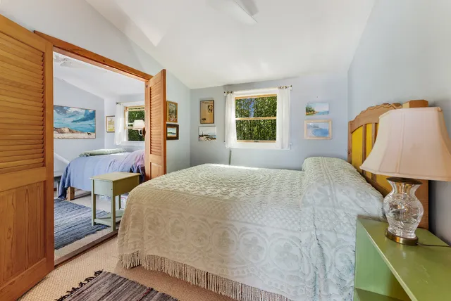 a room with furniture and paintings on the wall