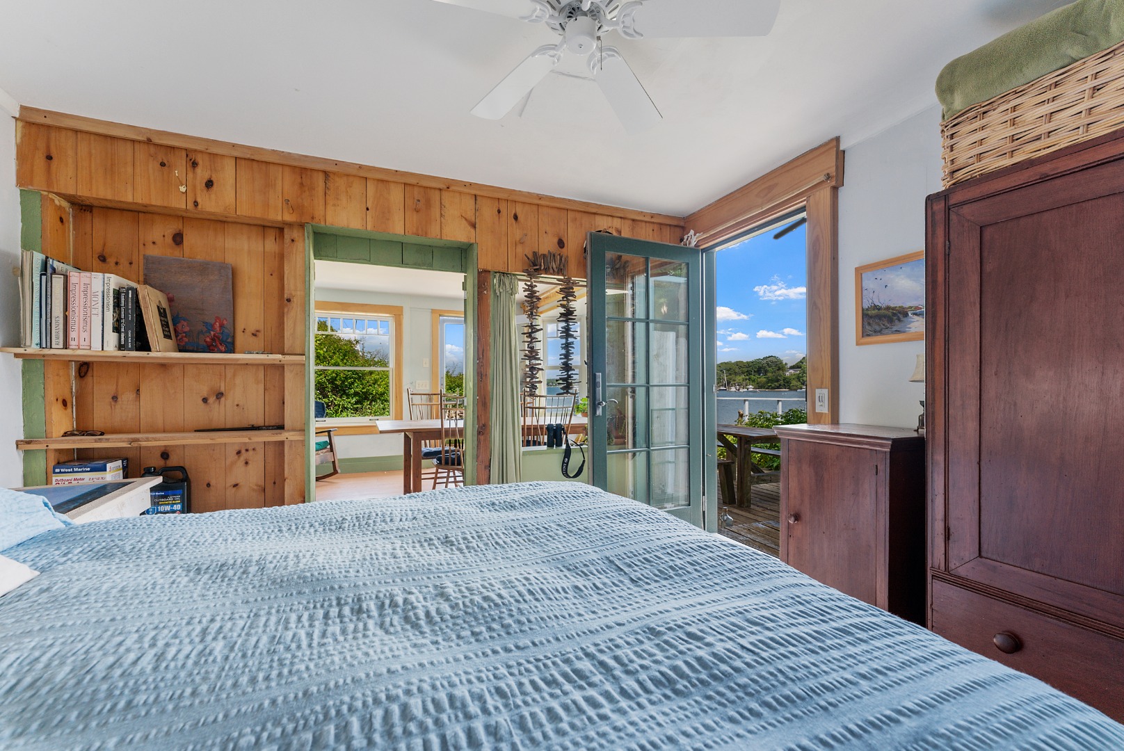 129 Beach Road Vineyard Haven, MA 02568 - Photo 34 of 71 a bedroom with a large bed and a chandelier