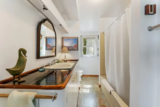 a living room with furniture rug and a table