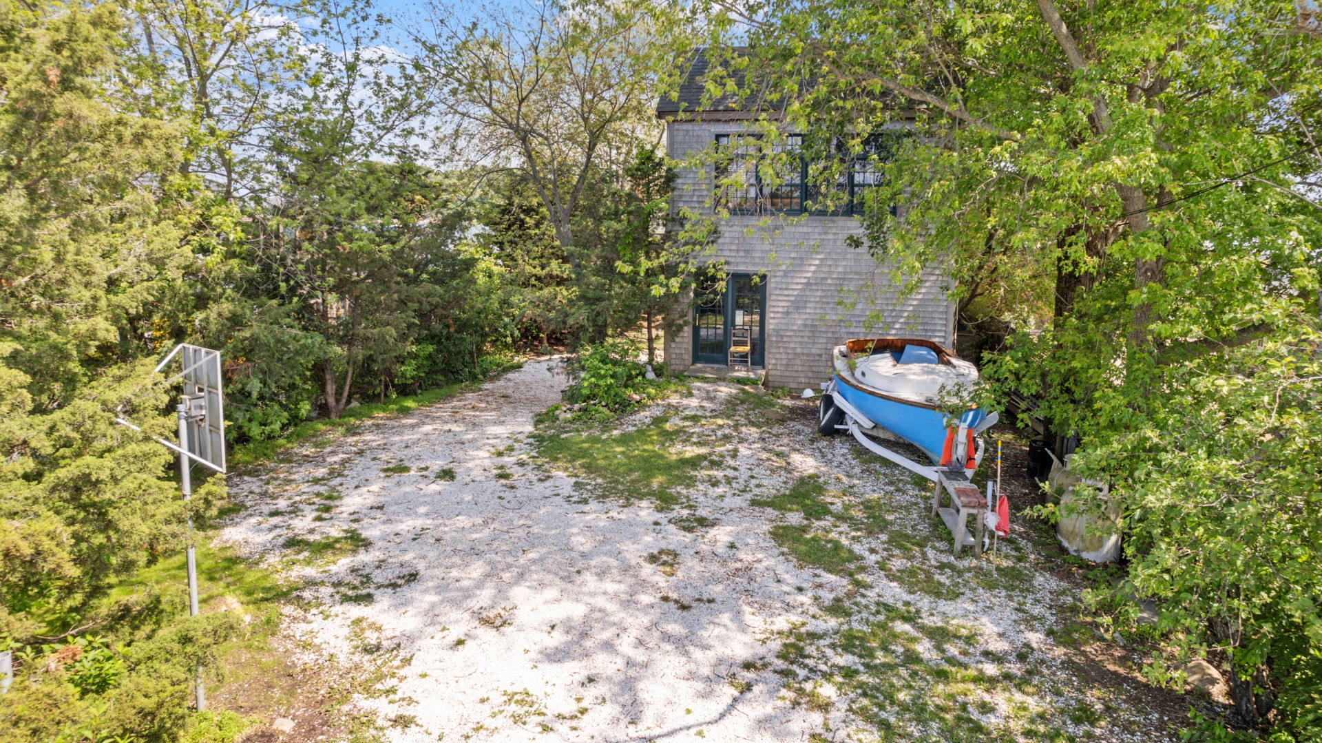 129 Beach Road Vineyard Haven, MA 02568 - Photo 48 of 71 a backyard of a house with wooden floor and yard