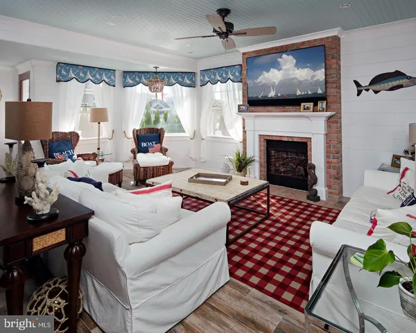 a living room with furniture fireplace and flat screen tv
