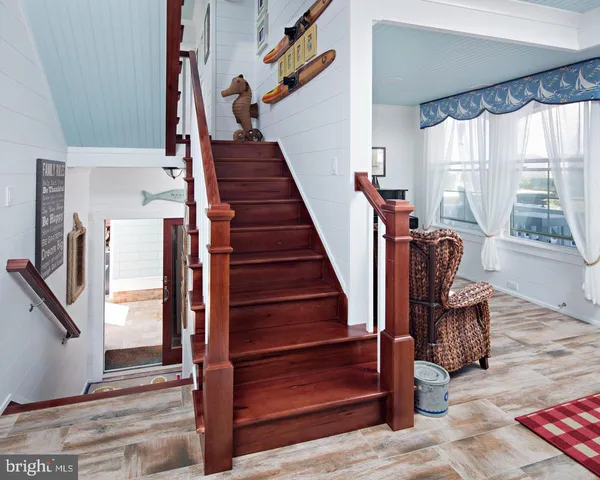 a view of entryway and hall with wooden floor