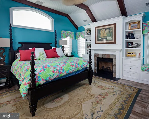 a bed sitting in a bedroom next to a window