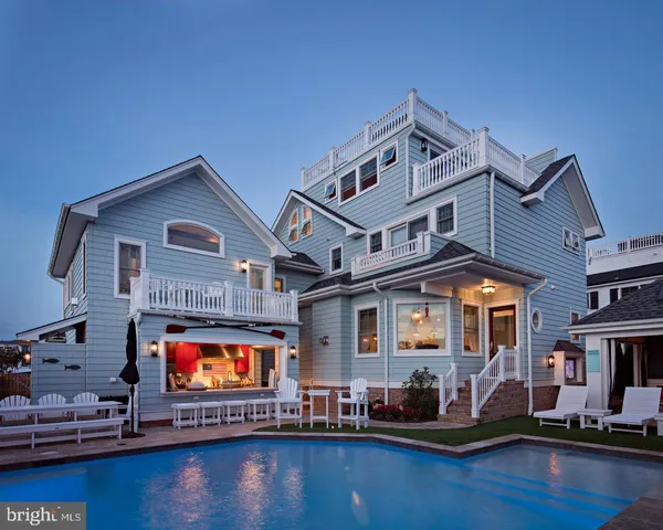 a front view of a house with swimming pool and a yard