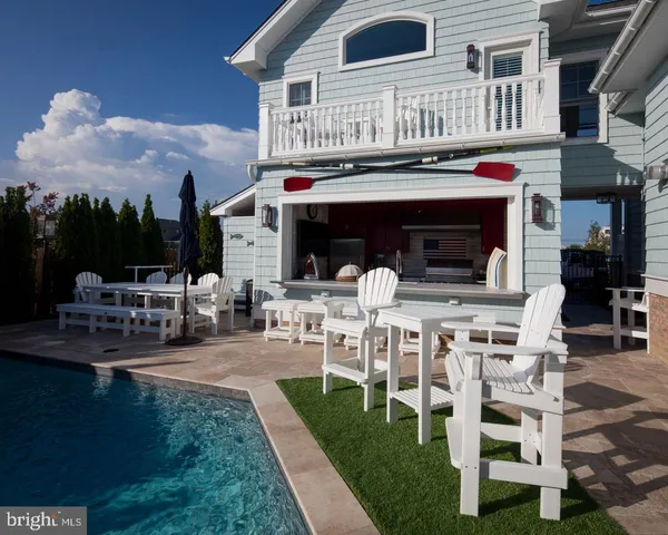 a view of a house with backyard porch and sitting area