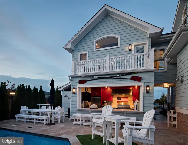 a view of roof deck with table and chairs a barbeque