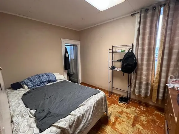 a bed sitting in a bedroom next to a window