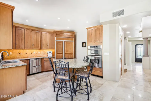 a view of a dining room with furniture and chandelier
