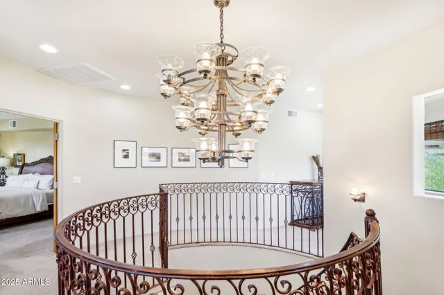 a bedroom with a bed and a chandelier
