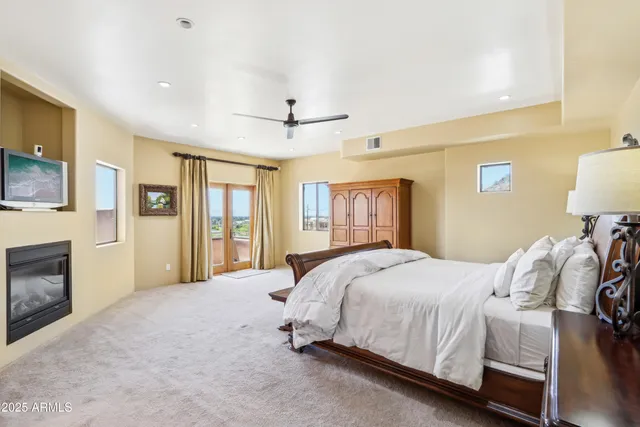 a bedroom with furniture and a ceiling fan
