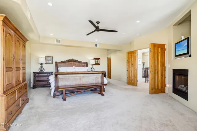 a bedroom with a large bed and a large window