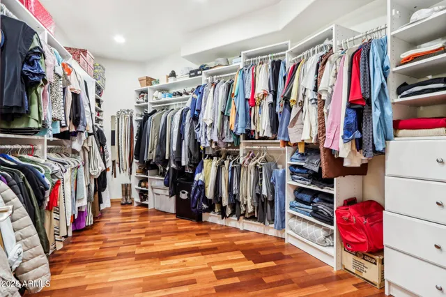 a spacious bathroom with a granite countertop sink a mirror a bathtub and shower