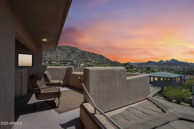 a view of a hallway with wooden floor and a mirror