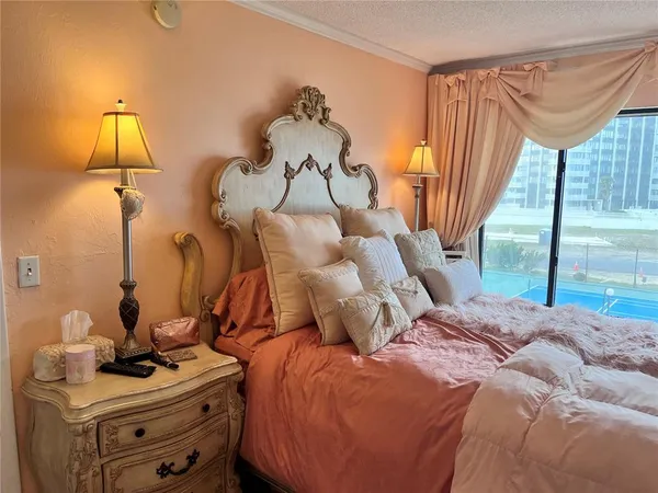 a bedroom with a bed and a chandelier