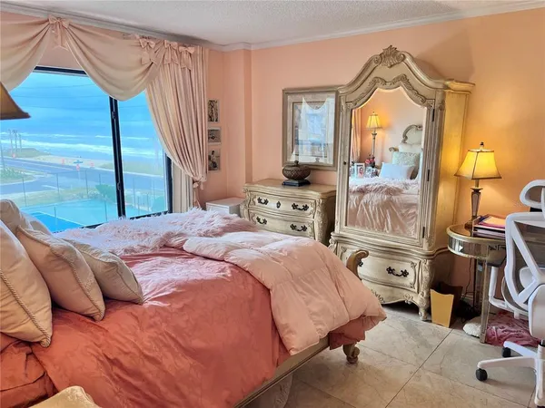 a bedroom with a bed a mirror and desk