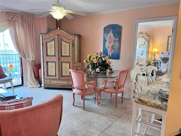 a dining room with furniture a chandelier and wooden floor
