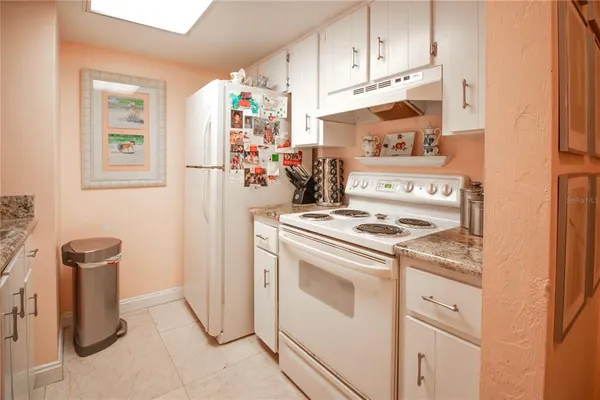 a kitchen with refrigerator a stove a washer and dryer