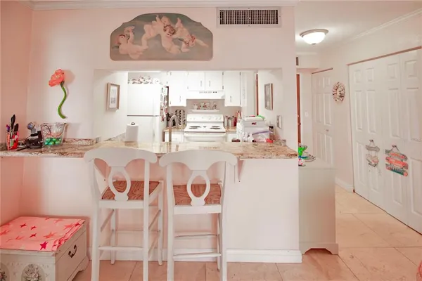 a dining room with furniture and a chandelier