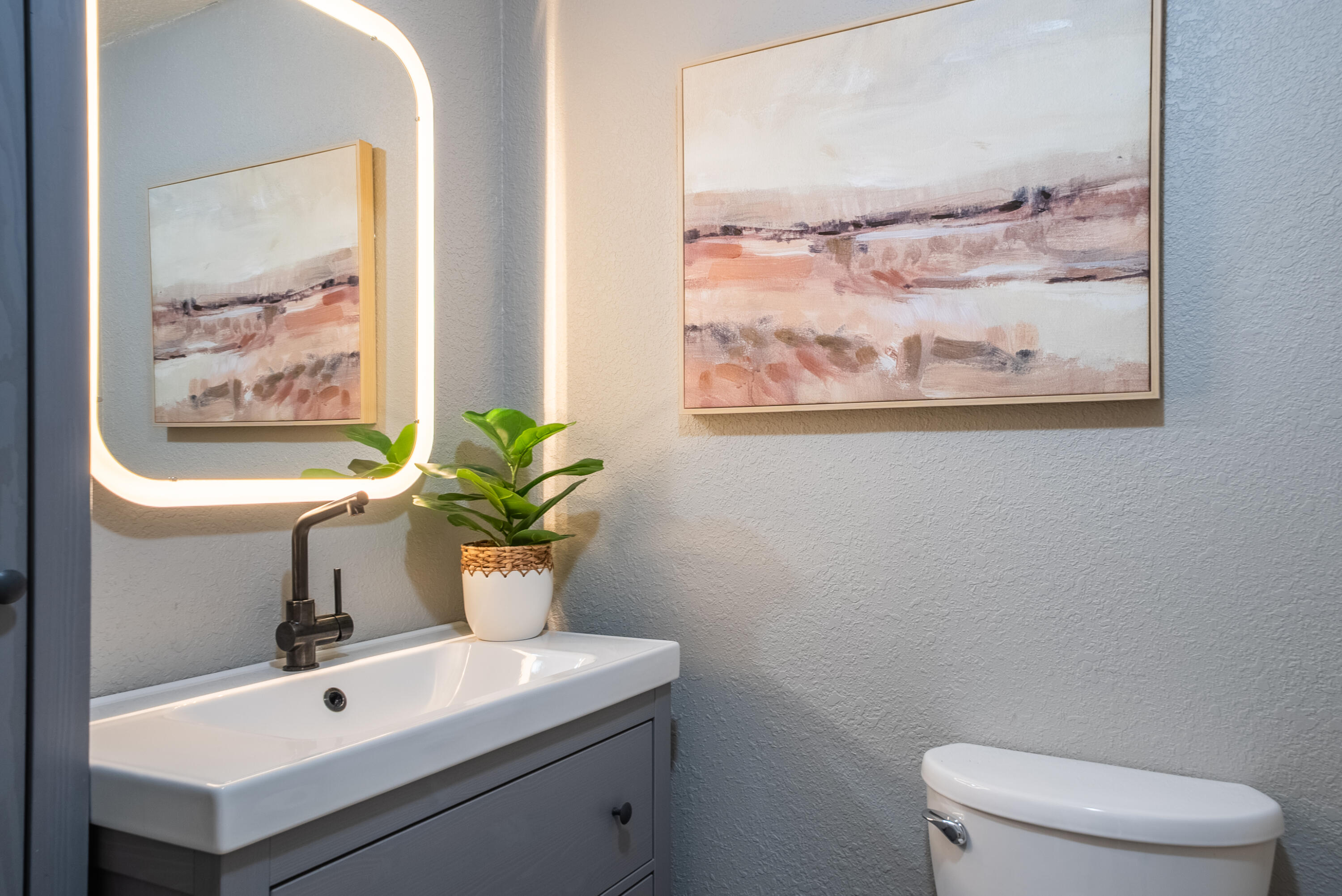 16879 Elsinore Road Bend, OR 97707 - Photo 16 of 48 a bathroom with a sink a toilet and a mirror