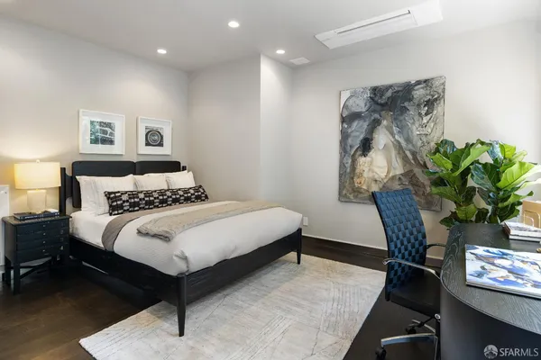 a bedroom with bed and a chair