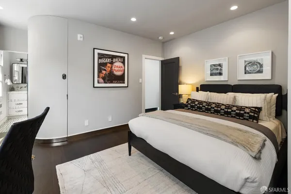 a bedroom with bed and painting on the wall