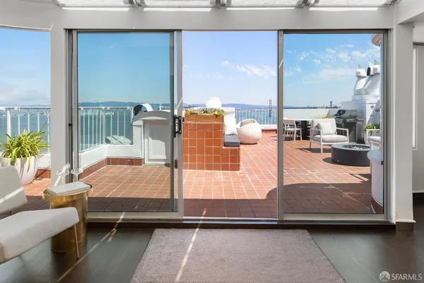 a bedroom with furniture and large windows