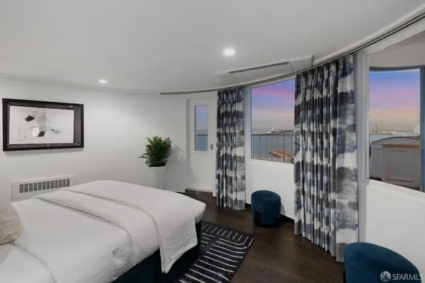 a bedroom with a bed and a potted plant