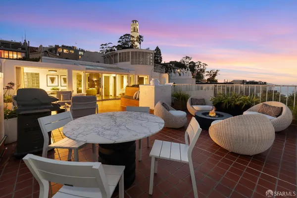a view of a balcony dining table and chairs