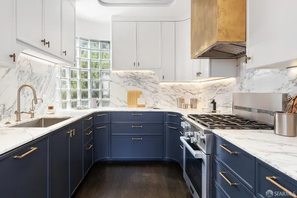 a kitchen with stainless steel appliances granite countertop a sink stove and cabinets