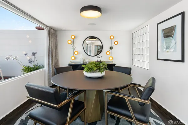 a view of a dining room with furniture and wooden floor