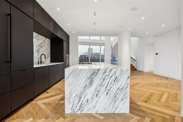 a living room with kitchen island granite countertop furniture and a fireplace