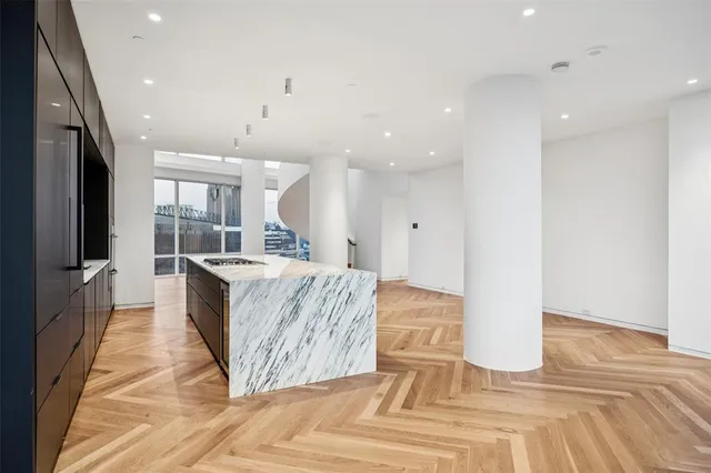 a living room with kitchen island granite countertop furniture and a fireplace