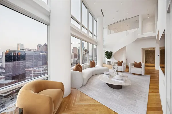a living room with furniture and a floor to ceiling window