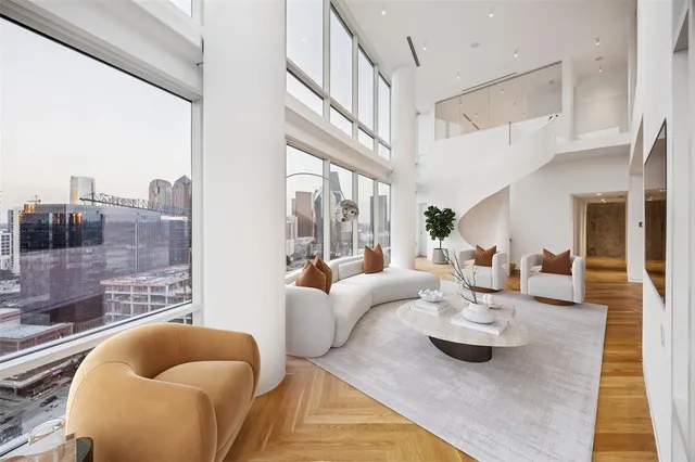 a living room with furniture and a floor to ceiling window