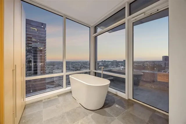 a room with a large window and a bath tub