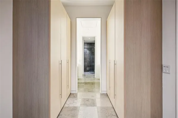 a view of a hallway with wooden shelves
