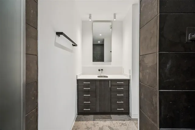 a bathroom with a sink and mirror