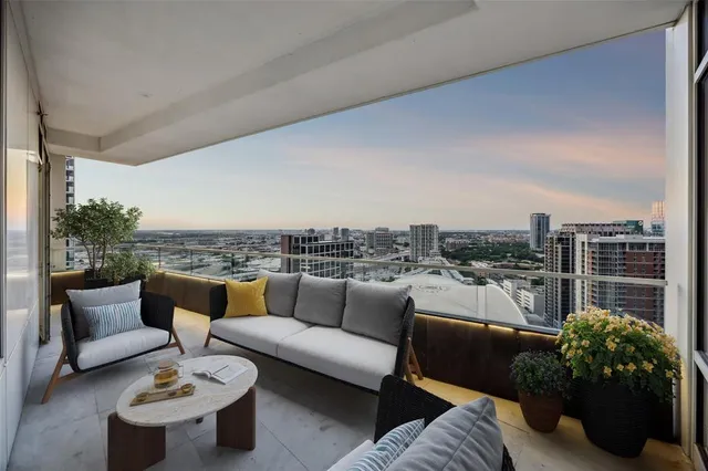 a roof deck with couches and potted plants