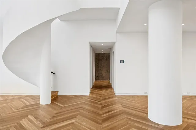 a view of a hallway view with wooden floor and staircase