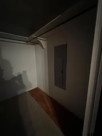 a view of living room and hallway with wooden floor