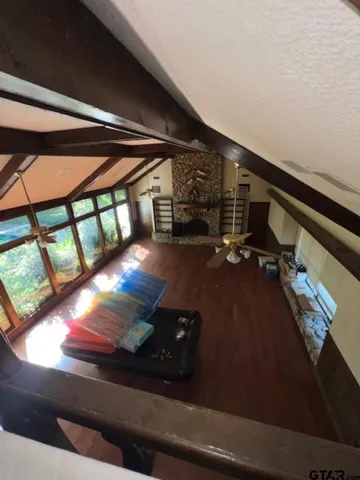 a view of a couches under an umbrella next to a yard