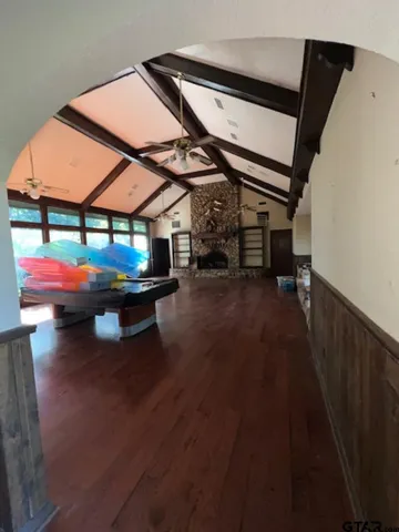 a living room with furniture window and kitchen view