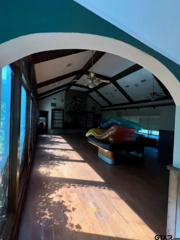 a view of a field of grass and trees