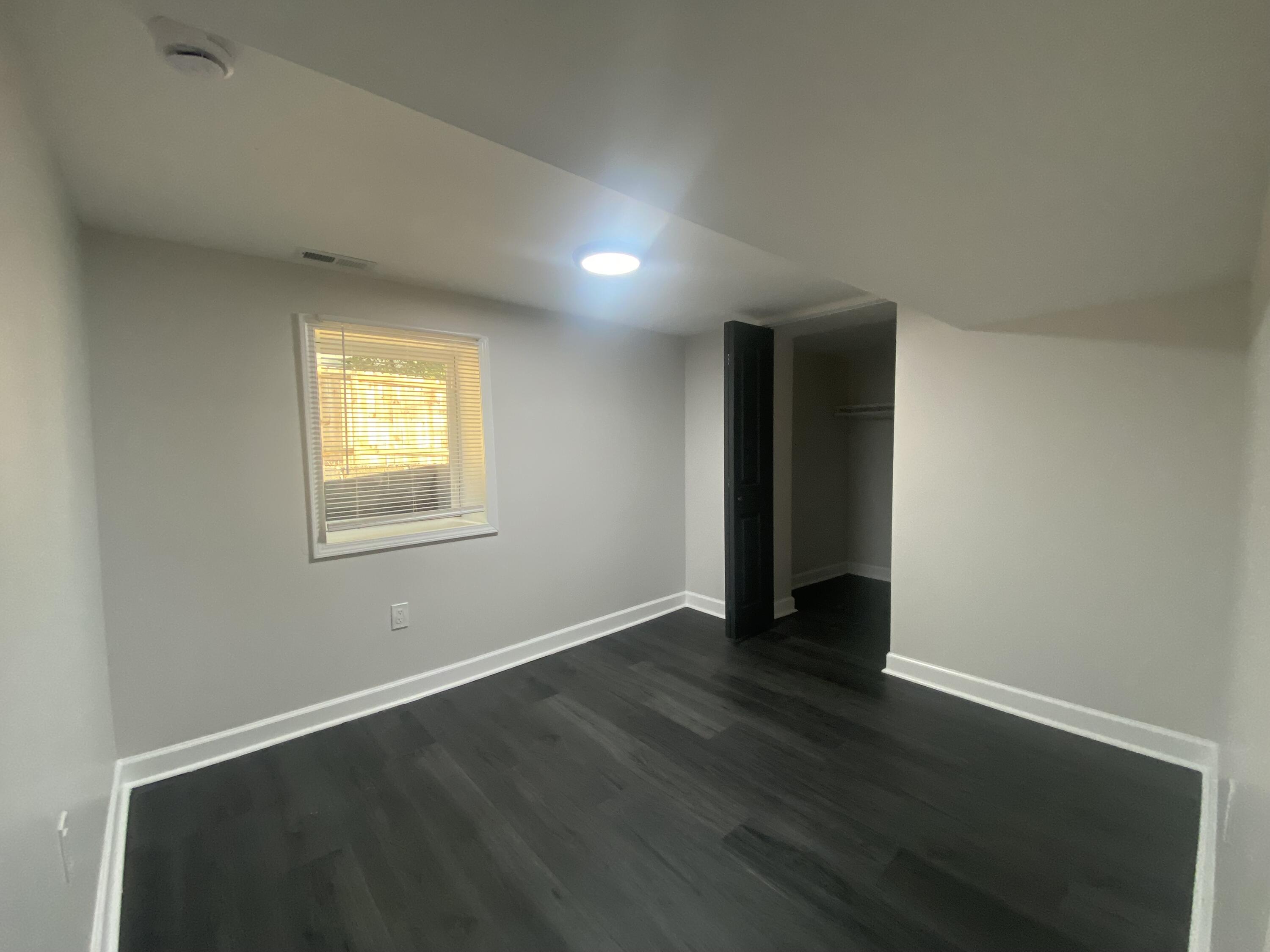 1165 Waite Street Gary, IN 46404 - Photo 16 of 18 an empty room with wooden floor and windows