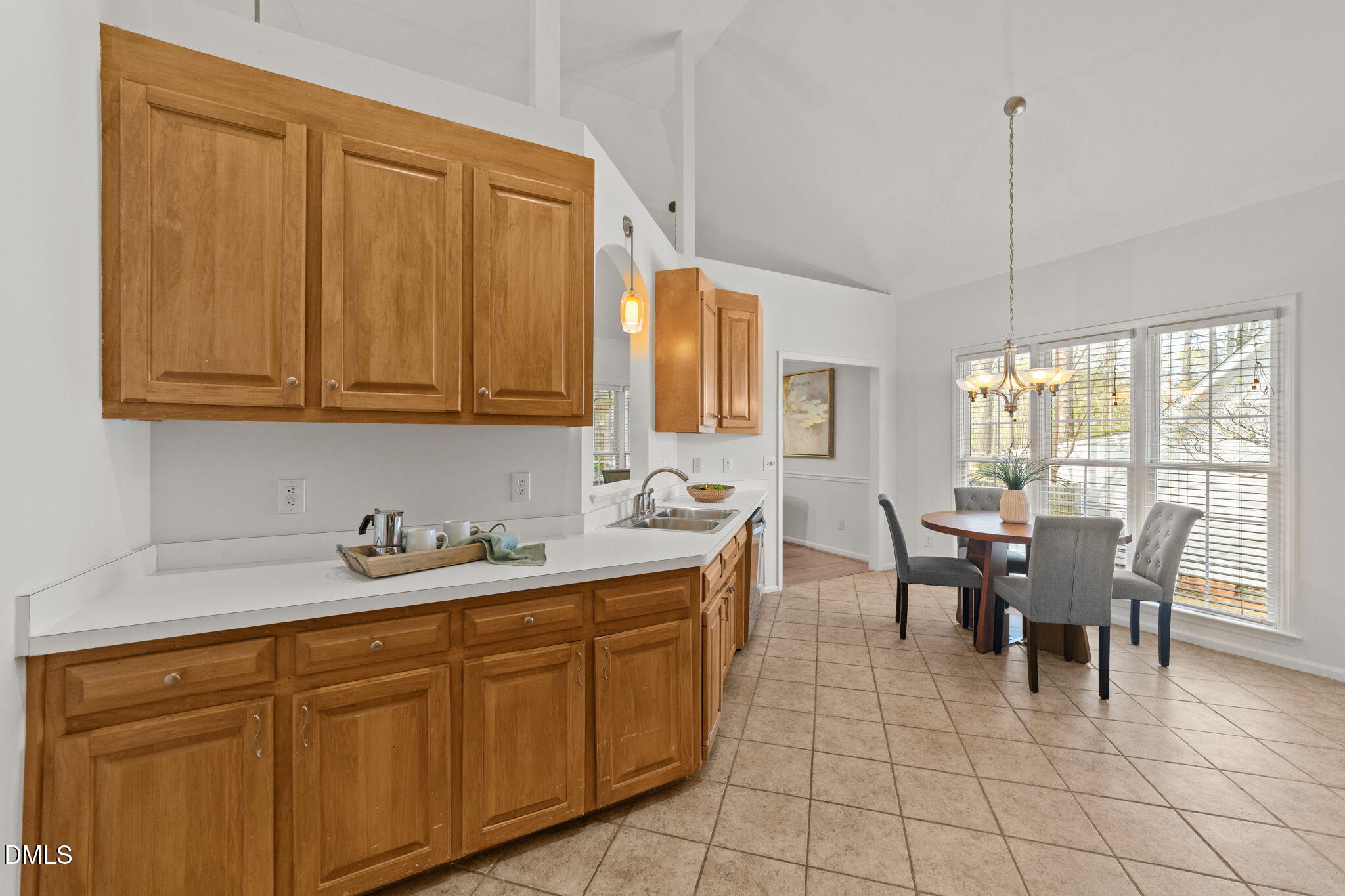 1641 Hall Boulevard Garner, NC 27529 - Photo 12 of 37 a dining hall with stainless steel appliances granite countertop a sink a dining table and chairs with wooden floor