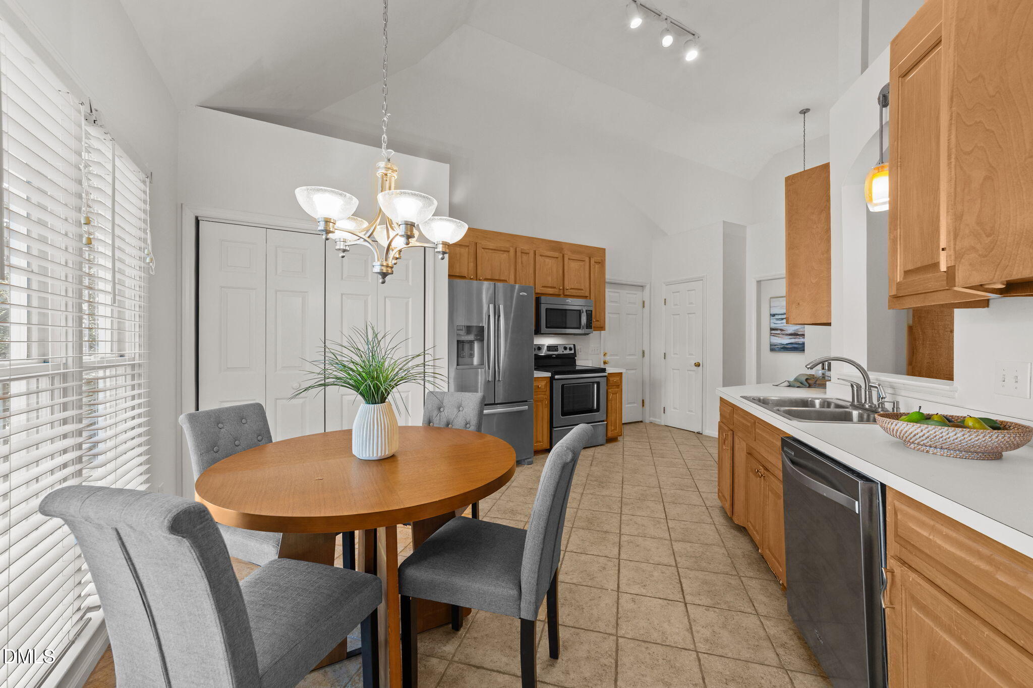 1641 Hall Boulevard Garner, NC 27529 - Photo 13 of 37 a dining room filled a chandelier and kitchen view