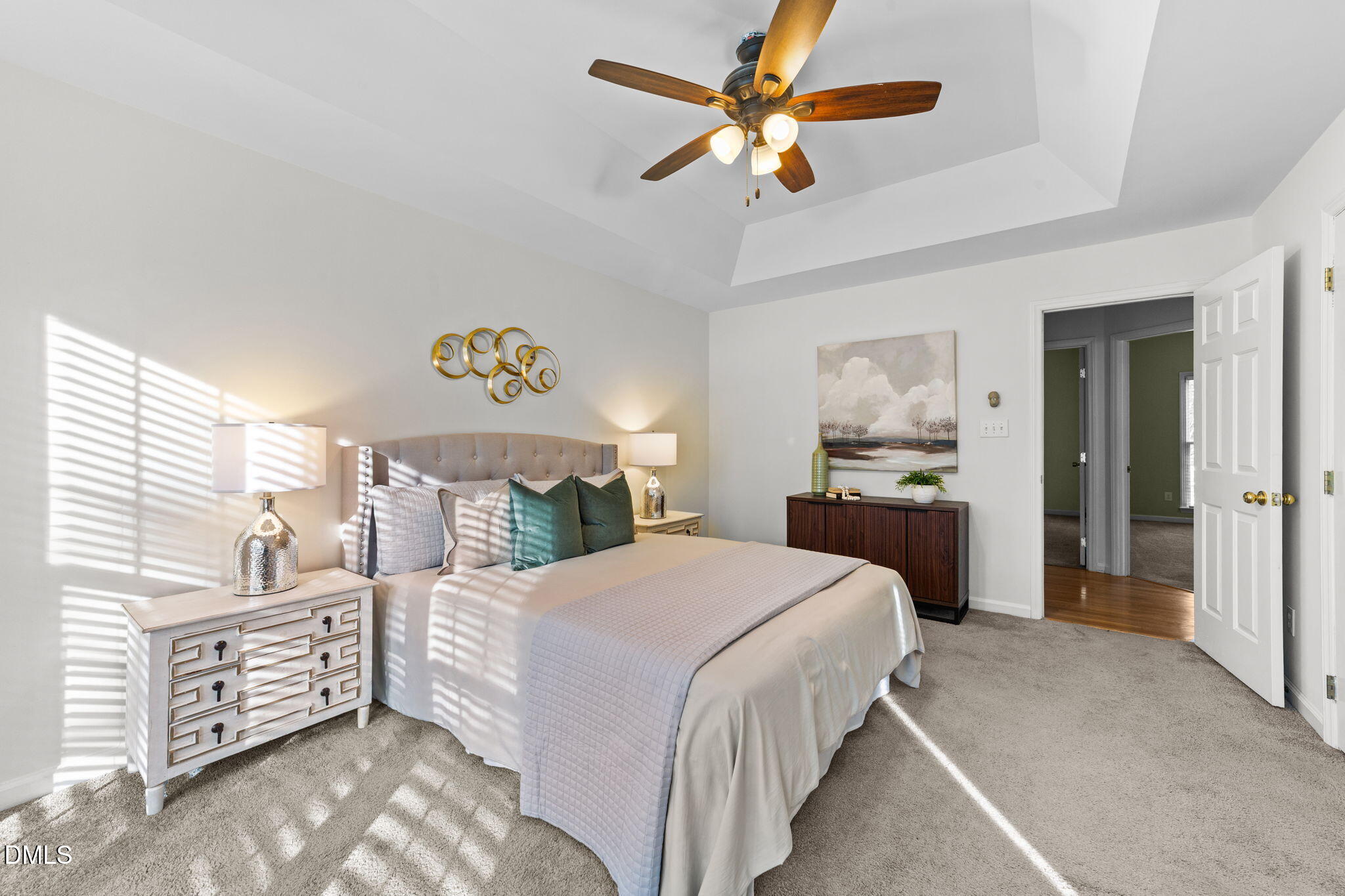 1641 Hall Boulevard Garner, NC 27529 - Photo 17 of 37 a spacious bedroom with a bed a dresser and a chandelier